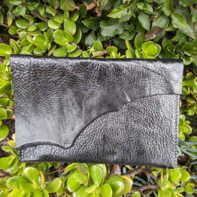 Raw edge leather clutch