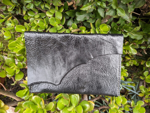 Raw edge leather clutch